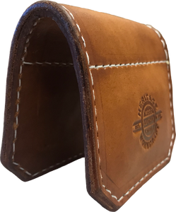 Brown leather shotgun barrel protector for trapshooting and other clay pigeon sports.